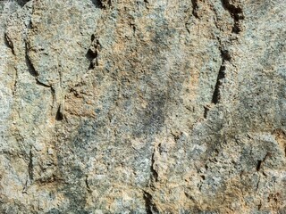 Rough surface of natural stone showing cracks and texture