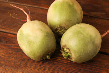 Whole fresh turnips on wooden table, closeup