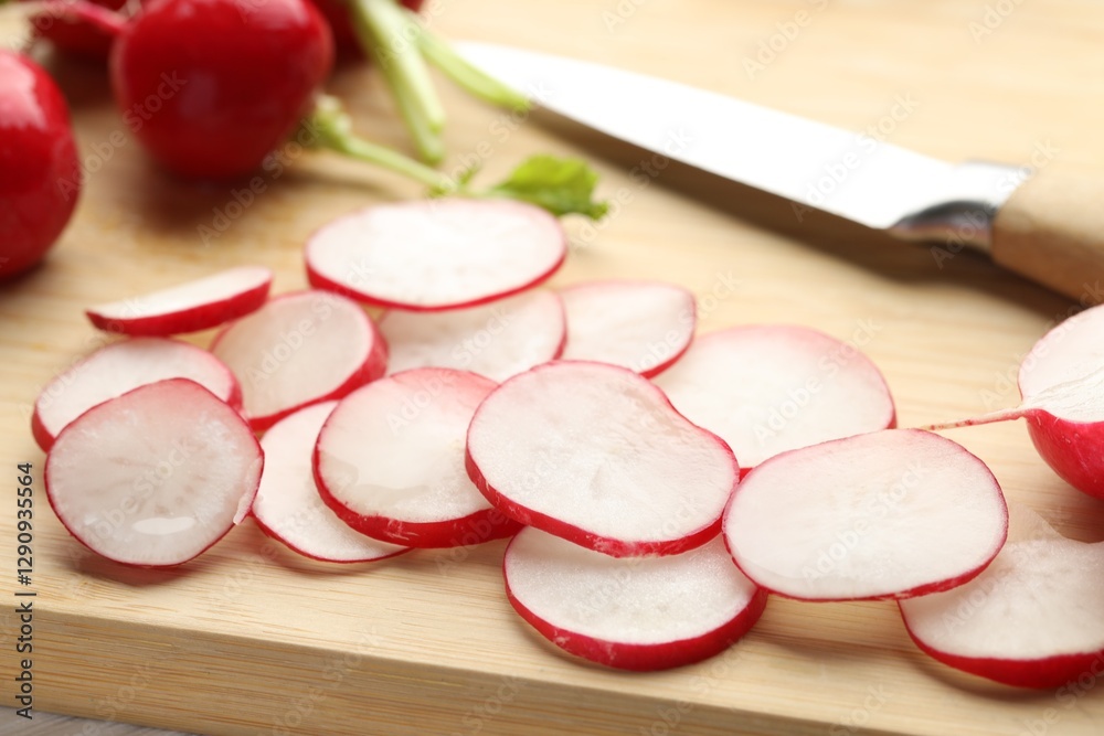 Wall mural Fresh whole and cut radishes on table, closeup