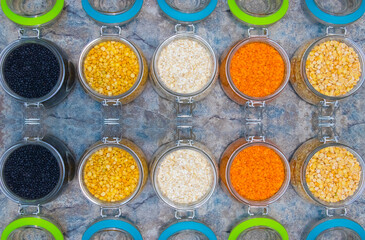 Legumes in glass next to each other on a retro background