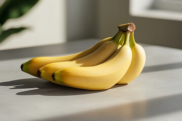 Bunch of ripe bananas on a gray countertop, bathed in sunlight, perfect for healthy eating