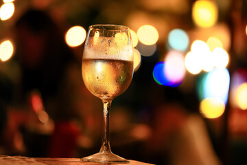 A glass of white wine on a blurred abstract background, alcohol, relaxation
