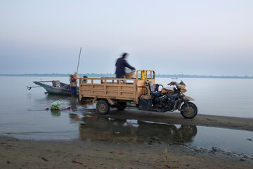 morning time view of many boat and car get Goods fot the market, Irrawaddy river, Nyaung-U, Myanmar