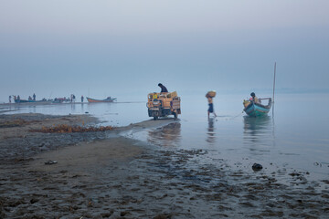 morning time view of many boat and car get Goods fot the market, Irrawaddy river, Nyaung-U, Myanmar
