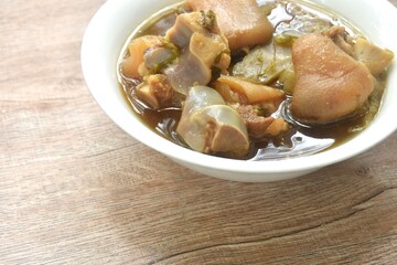 boiled braised salty pork leg and chop cabbage in Chinese herb soup in bowl 