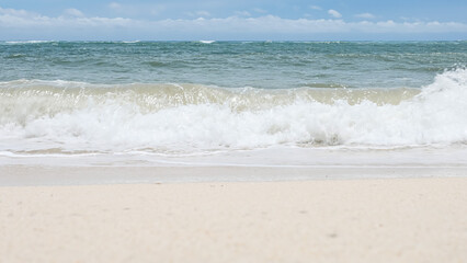 BALI, INDONESIA - JANUARY 22, 2018: Clean white sand of Pandava Beach and crushing Indian Ocean waves, Bali.