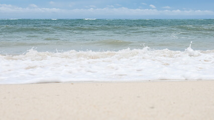 BALI, INDONESIA - JANUARY 22, 2018: Clean sand of pristine Pandava Beach and Indian Ocean waves, Bali.