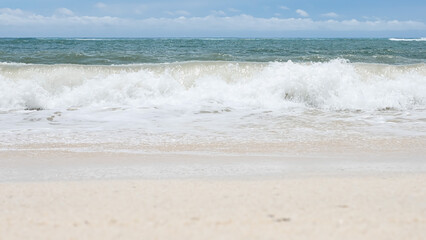 BALI, INDONESIA - JANUARY 22, 2018: White clean sand of Pandava Beach and Indian Ocean waves, Bali.