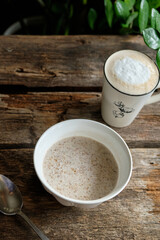 sweet milk buckwheat with butter. Wooden background.