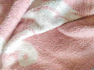 Closeup of soft, textured fabric in pink and white.  Ideal for textile designs, website banners, or blog posts on home d?cor  comfort. The plush texture evokes warmth and coziness.