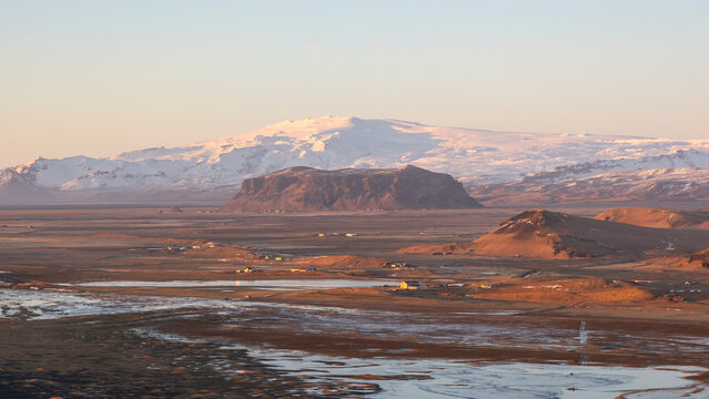 View of eyjafjallajokull volcano and eyjafjoll glacier at sunset with serene landscape and rugged terrain, Dyrholaey, Vik i Myrdal, Iceland.