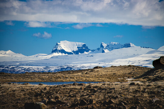 View of majestic snowy mountains under a vast sky, Egilsstaoir, Iceland.