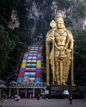Kuala Lumpur, Malaysia - 11 April 2023: View of Batu Caves with colorful statue of Murugan and historic temple steps, Kuala Lumpur, Malaysia.