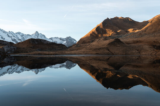 View of serene Lacs de Fenetre with majestic mountains and tranquil reflection, La Fouly, Switzerland.