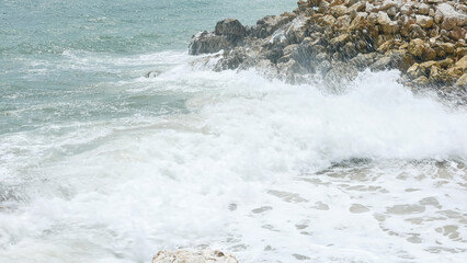 BALI, INDONESIA - JANUARY 22, 2018: Relaxing powerful ocean waves hit rocks near Pandawa Beach,...
