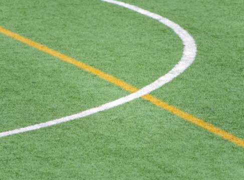 Close up of soccer field markings on artificial green turf