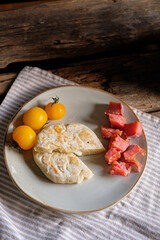 cheese flatbread, yellow cherry tomatoes and trout pieces on a plate with 