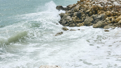 BALI, INDONESIA - JANUARY 22, 2018: Ocean Ocean waves hit rocks near Pandawa Beach, Bali.