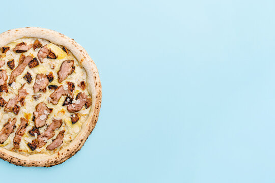Top view gourmet pizza with duck sous-vide and figs on pastel background