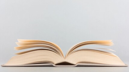 Open book with fluttering pages creates an inviting atmosphere f