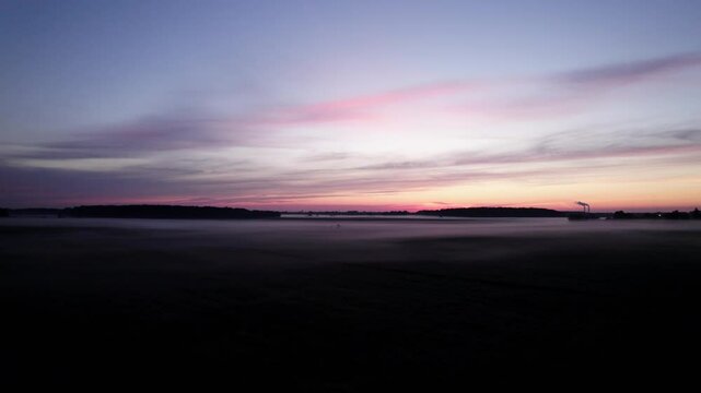 Establishing drone shot of Monroe Power Plant and misty sunrise in Monroe, Michigan, USA