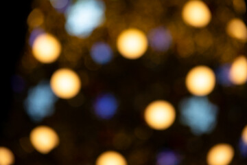 Blurred bokeh of blue and white lights against a dark