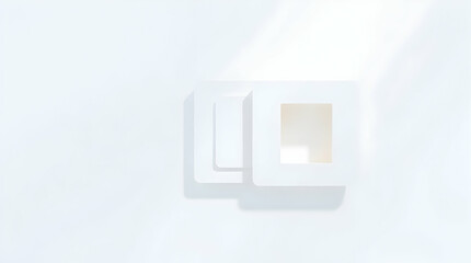 A minimalist, white-on-white image featuring two overlapping square frames, one with a smaller square cut-out, casting subtle shadows.