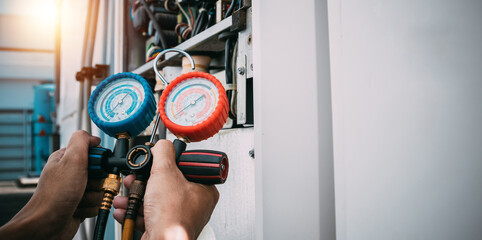 Technician is checking air conditioner refrigerant leak.