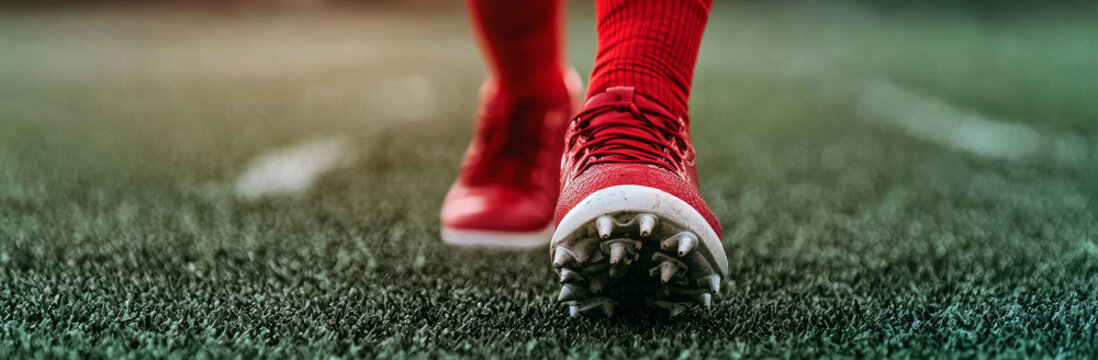 close up of red soccer cleat on grassy field, showcasing athleticism and focus