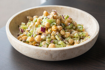 delicious healthy salad with chickpeas, cucumber, and feta cheese close-up