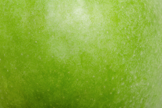 Green apple texture as a macro photo background.
