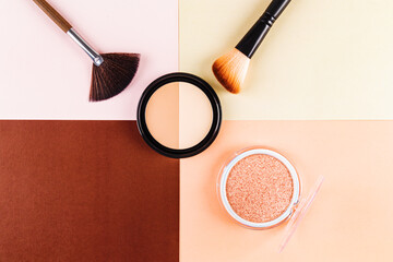 Makeup essentials with brushes on a pastel background