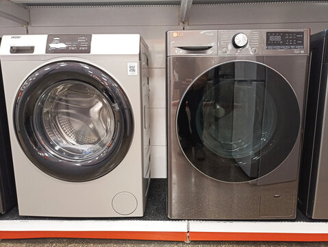 Modern washing machines displayed in store &mdash; haier and lg models