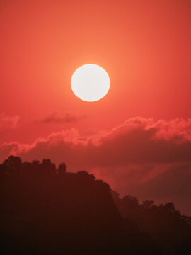 Orange sunset over silhouette mountain horizon