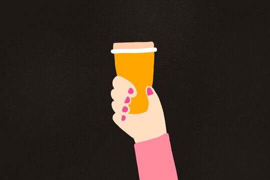 Hand holding a disposable coffee cup on a dark background