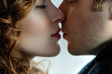 Close-up shot of a person kissing a woman, romantic moment