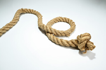 Closeup view of ropes string with a knot isolated over a white background