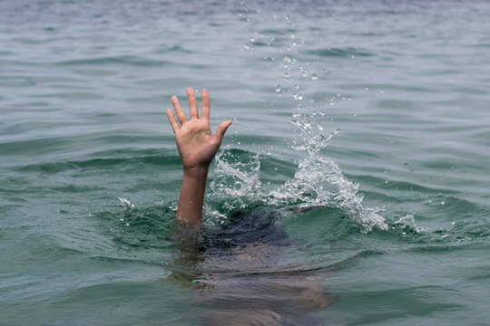 Hand Reaching Out of Water Signaling for Help and Rescue