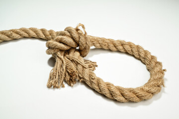 Closeup view of ropes string with a knot isolated over a white background
