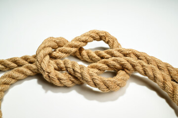 Closeup view of ropes string with a knot isolated over a white background