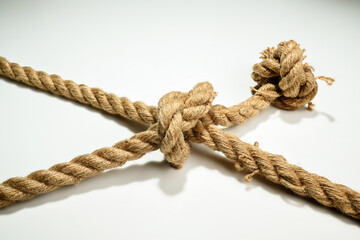 Closeup view of ropes string with a knot isolated over a white background