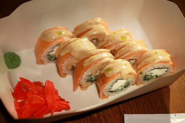 delicious fresh rolls with wasabi and ginger in a cardboard plate
