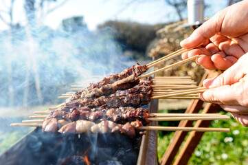 Arrosticini di pecora or sheep skewers is a typical food of Abruzzo in Italy cooked on Furnacella characteristic brazier for their cooking