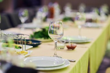 A table with various festive treats. Wine glass close-up