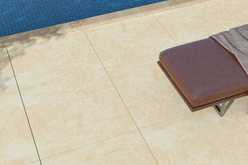 3D Render of Close-Up of Luxury Poolside Lounge Chair on Textured Stone Tiles Beside Clear Water