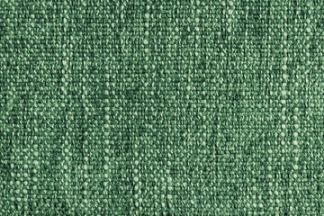 Green Jacquard fabric with large loose woven, coarse weave texture upholstery cloth. Textile background, furniture textile material, wallpaper, backdrop. Cloth structure close up, macro.