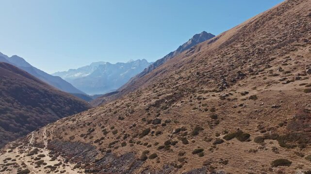 Mountain landscape revealing dramatic Himalayan panorama, peaks stretching across rugged Nepalese terrain under intense sunlight in the Shomare to Dingboche Route