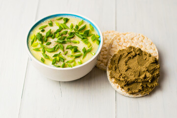 Healthy food, liver pate with butter and green onions in a bowl and beef liver pate on rice bread...
