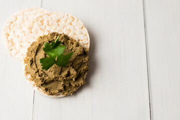 Healthy food, crispy rice cakes and liver pate on light table