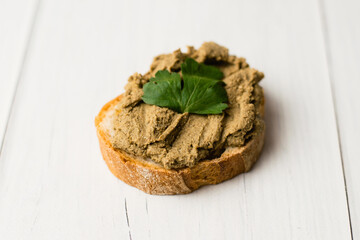 Healthy food, delicious beef liver pate on a baguette with a crispy crust on a light table